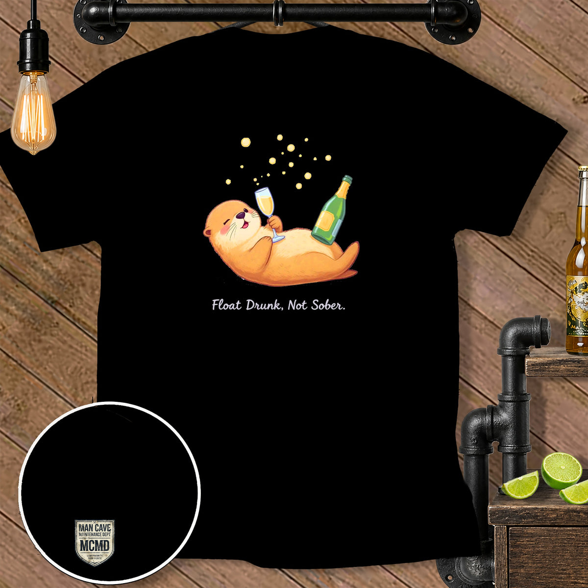 Black t-shirt with cartoon otter holding champagne and a bottle, text reads "Float Drunk, Not Sober."