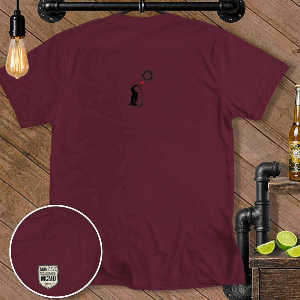 Maroon t-shirt with a small penguin graphic and a chest logo.