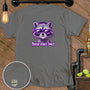Gray t-shirt with purple graphic of raccoon wearing headphones and sunglasses, text "TRASH VIBES ONLY".