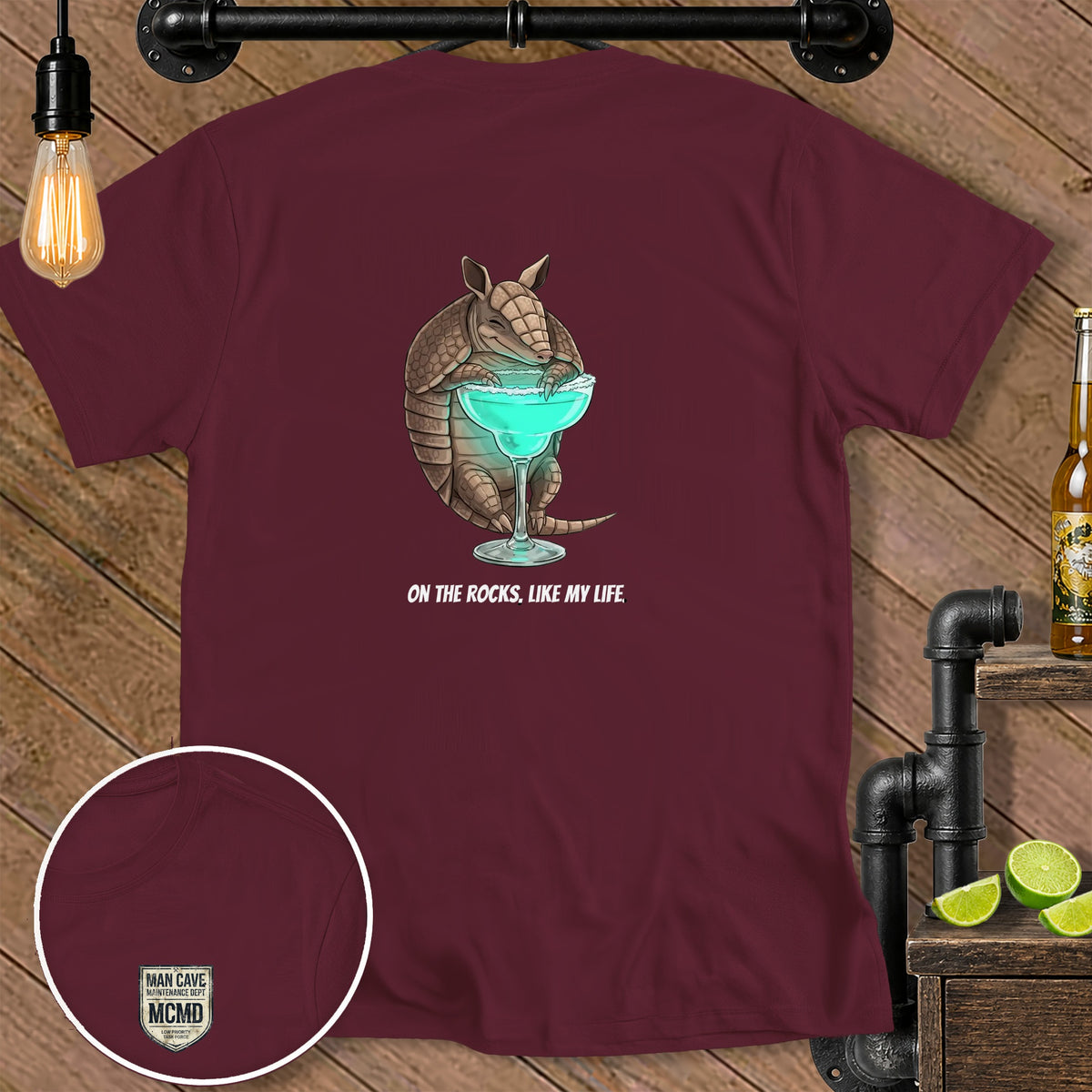 Maroon t-shirt with armadillo holding margarita and text "ON THE ROCKS, LIKE MY LIFE."