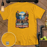 Yellow t-shirt with graphic of US and Canadian flags, lake, and text 