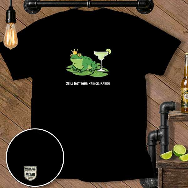 Black t-shirt with a frog wearing a crown and a margarita, text "STILL NOT YOUR PRINCE, KAREN."