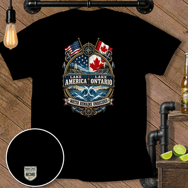 Black t-shirt featuring Lake America Ontario emblem with US and Canadian flags and waves.