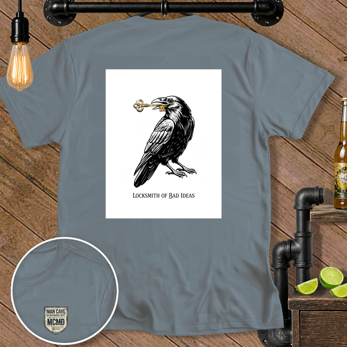 Gray t-shirt with a raven holding a key and the text "LOCKSMITH OF BAD IDEAS".
