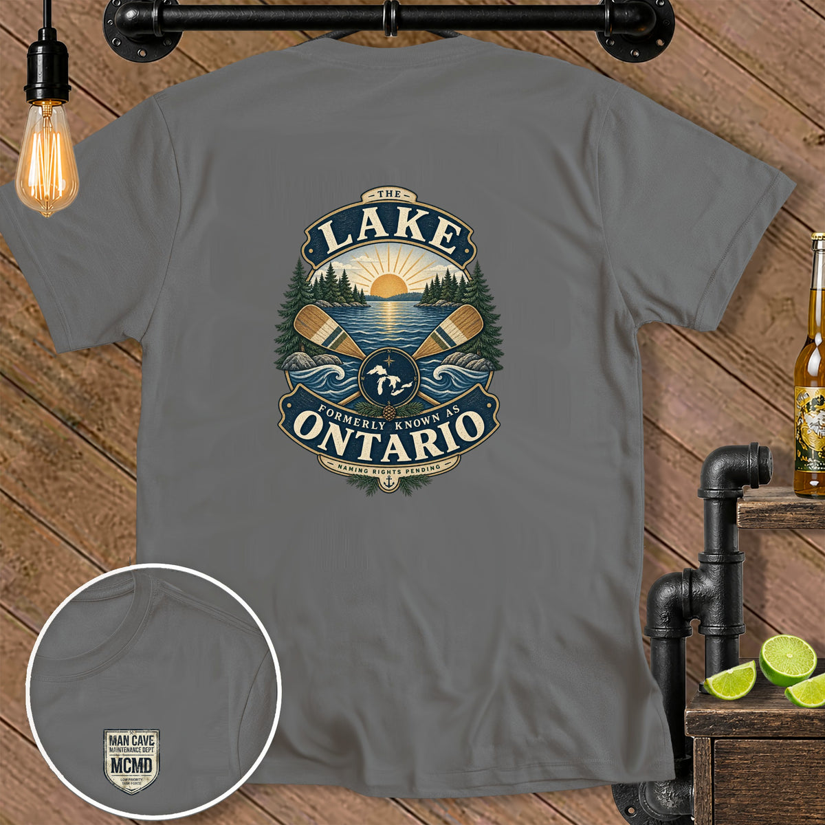 Grey t-shirt with a graphic of a lake scene, oars, and text "The Lake Formerly Known As Ontario".