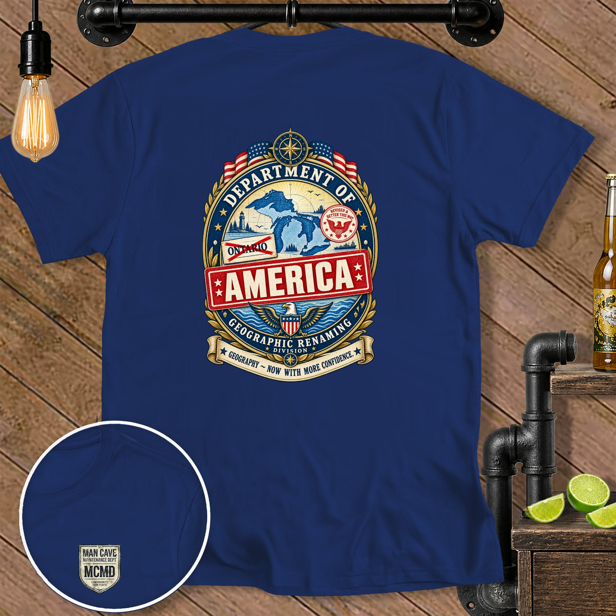 Navy blue t-shirt with "Department of America Geographic Renaming" graphic and "Man Cave Maintenance Dept" logo.