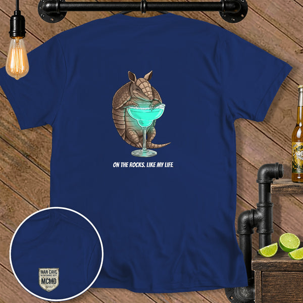 Navy t-shirt with armadillo drinking margarita and text "ON THE ROCKS, LIKE MY LIFE."