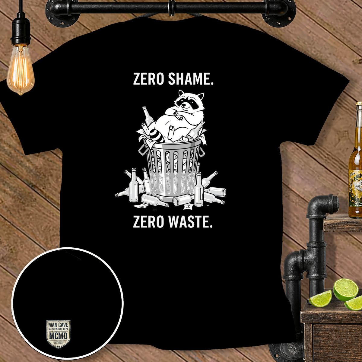 Black t-shirt with raccoon in trash bin and text "ZERO SHAME. ZERO WASTE."