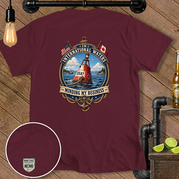 Maroon t-shirt with "International Waters, USA? Minding My Business" graphic.