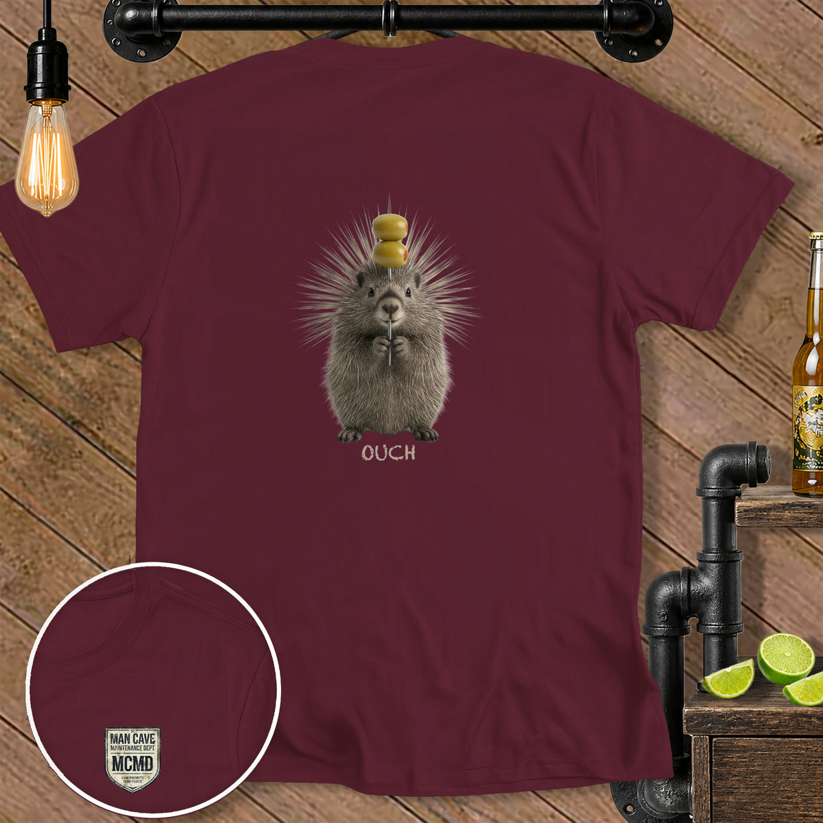 Maroon t-shirt with a porcupine holding a toothpick and olives, text reads "OUCH".