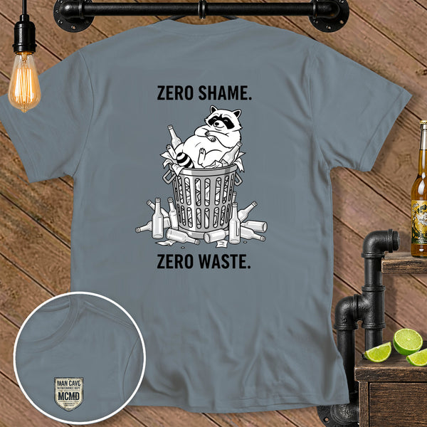 Grey t-shirt with raccoon in trash bin, text "ZERO SHAME." and "ZERO WASTE."