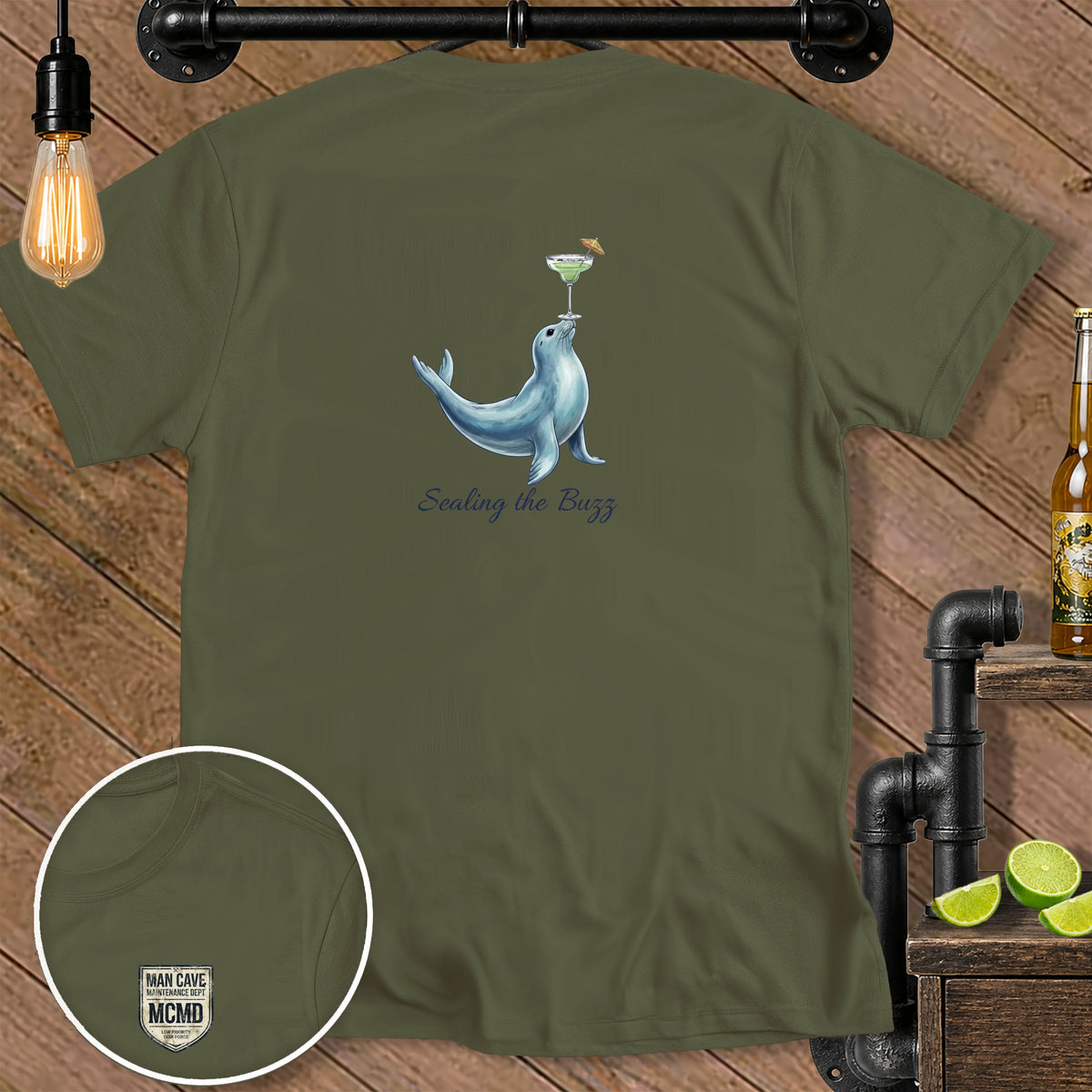 Olive green t-shirt with seal balancing a margarita, and "Sealing the Buzz" text.