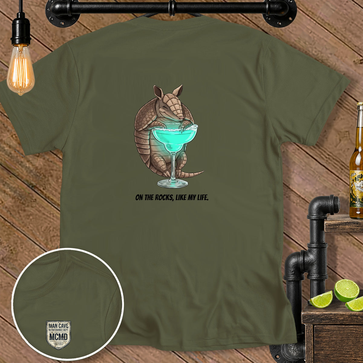 Olive green t-shirt with armadillo holding cocktail and text "ON THE ROCKS, LIKE MY LIFE."