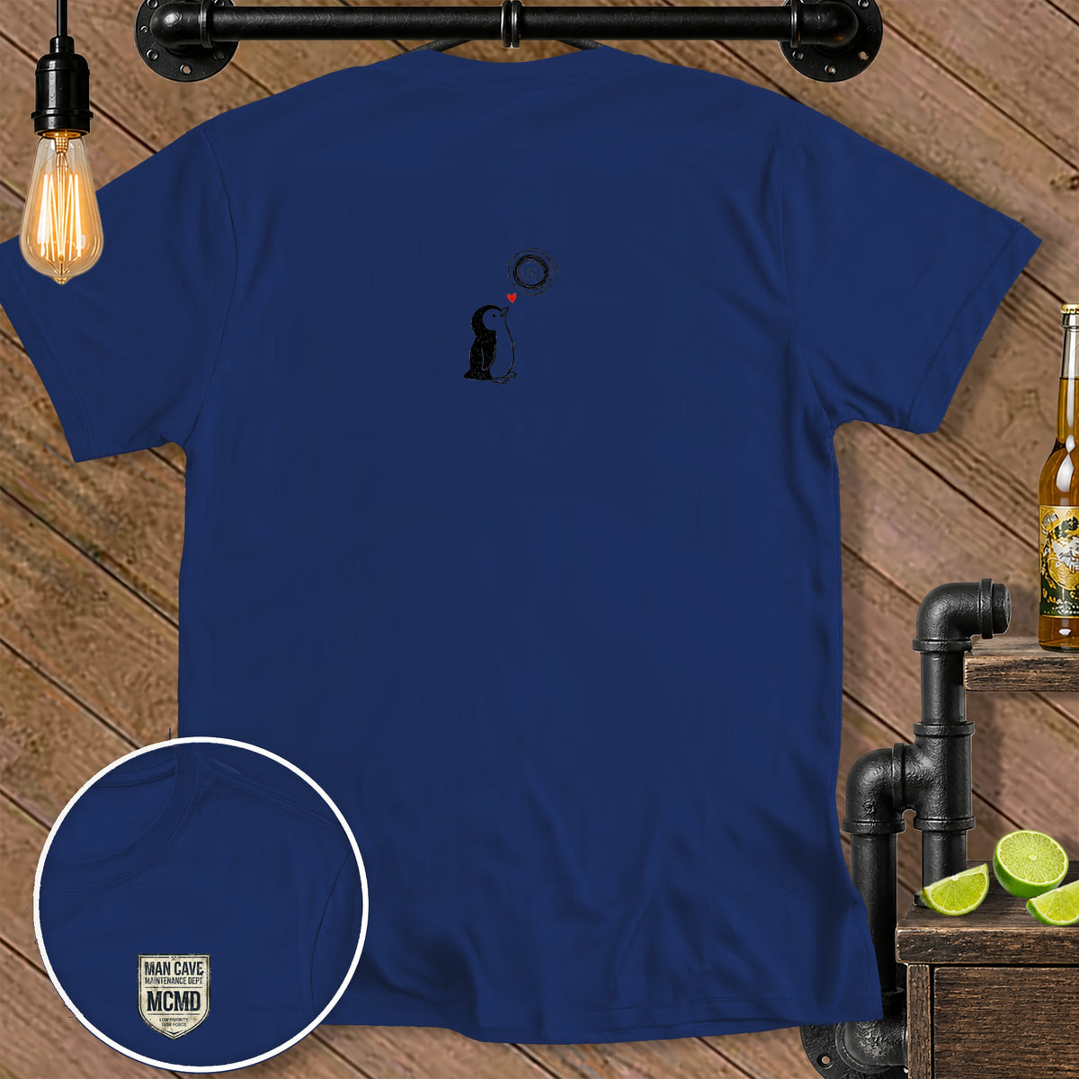 Navy blue t-shirt with a sketched penguin, heart, and sun design.