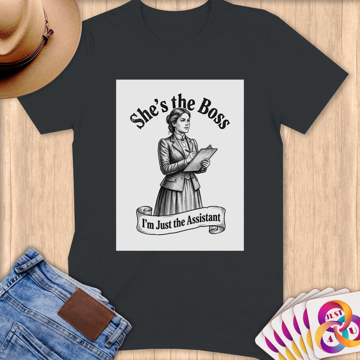T-shirt with "She's the Boss, I'm Just the Assistant" text and illustration.
