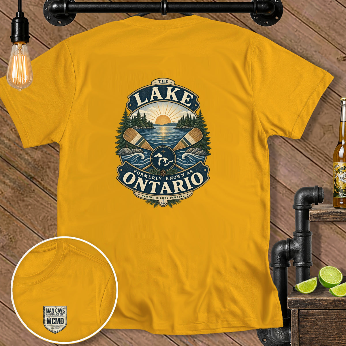 Yellow t-shirt with a graphic of a lake scene, oars, and text "The Lake Formerly Known As Ontario".