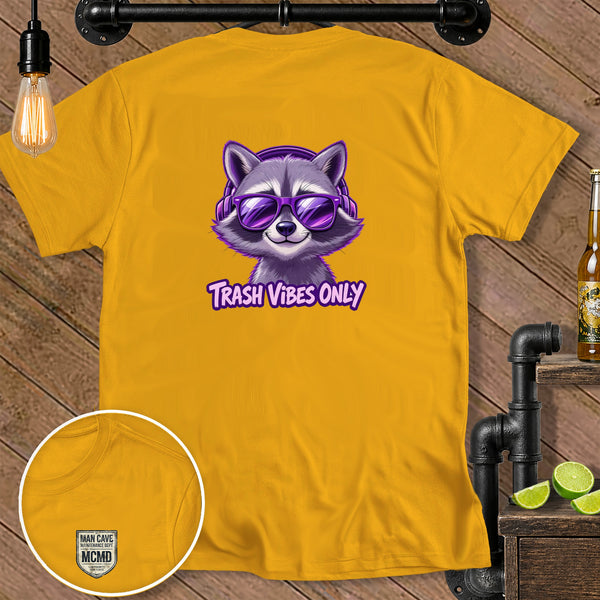 Yellow t-shirt with a cartoon raccoon wearing headphones and sunglasses with text "Trash Vibes Only".