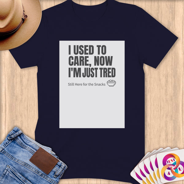 Navy t-shirt with "I USED TO CARE, NOW I'M JUST TRED Still Here for the Snacks" text.