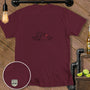 Maroon t-shirt with cartoon alligator and bird graphic with a red heart.