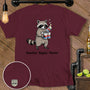 Maroon t-shirt with raccoon holding cans and text "Snackin', Sippin', Thrivin'".