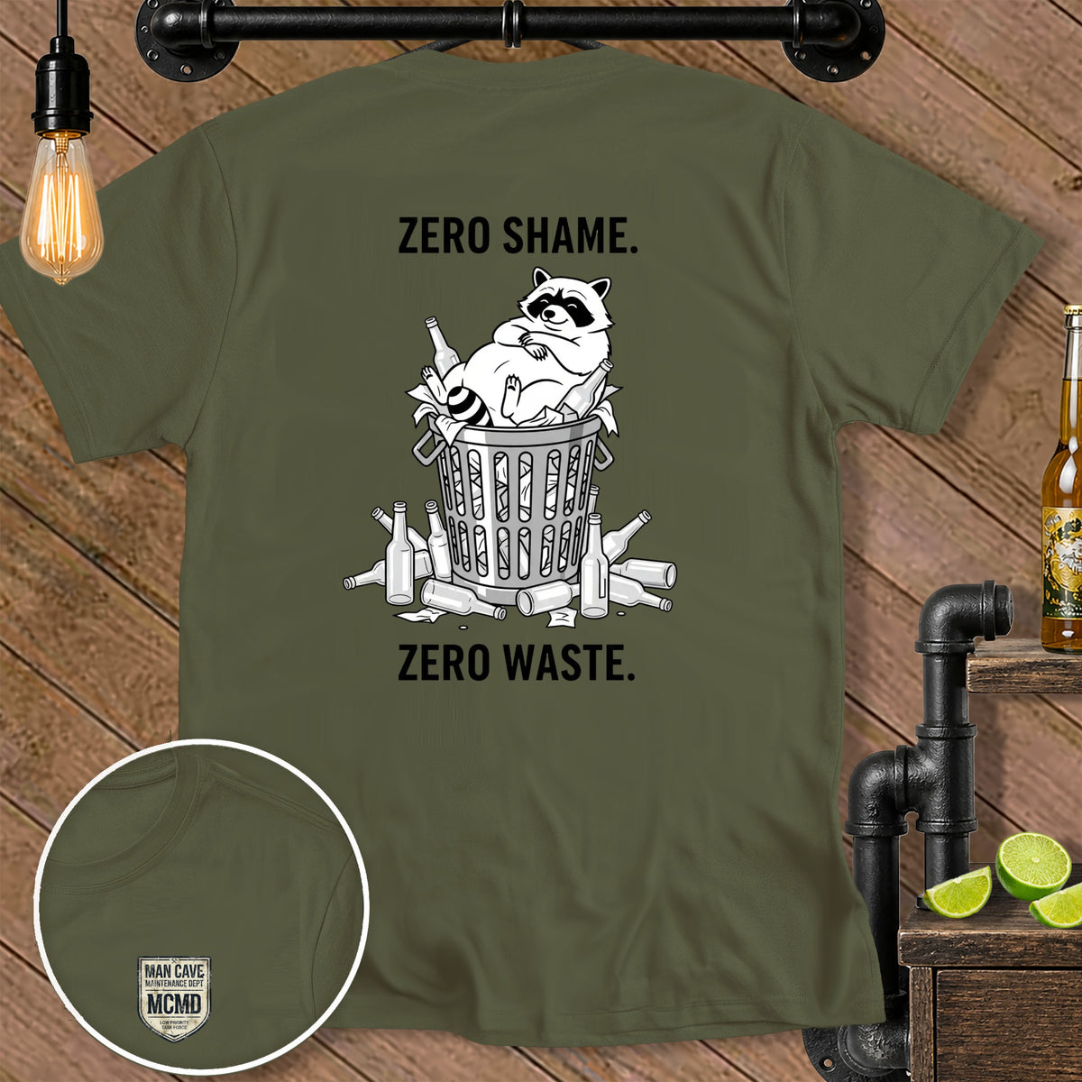 Olive t-shirt with "ZERO SHAME. ZERO WASTE." and a raccoon in trash.