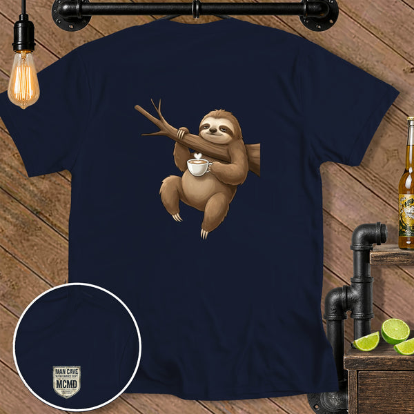 Sloth hanging from a branch holding a coffee cup with a heart design.