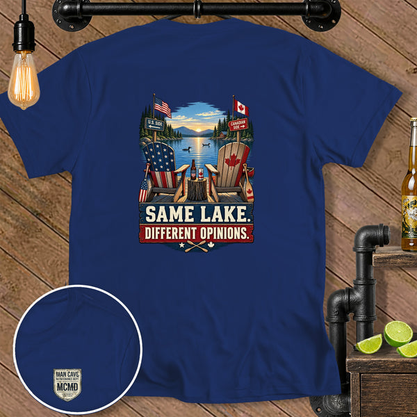 Blue t-shirt with US and Canadian flags, chairs, and text "SAME LAKE. DIFFERENT OPINIONS."