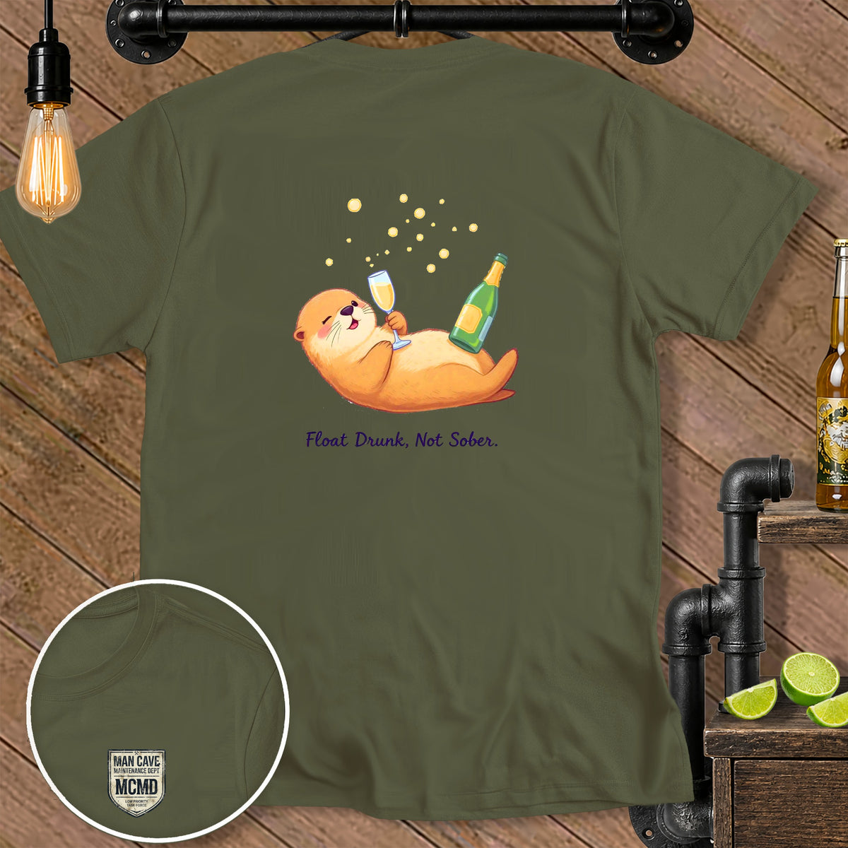 Olive green t-shirt with an otter holding champagne, text "Float Drunk, Not Sober."