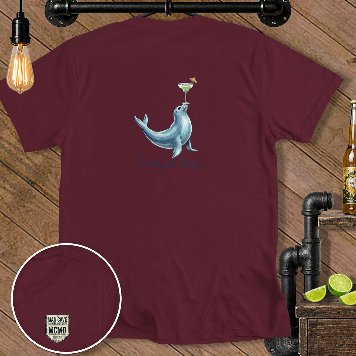 Maroon t-shirt with a seal balancing a margarita and text "Sealing the Buzz."