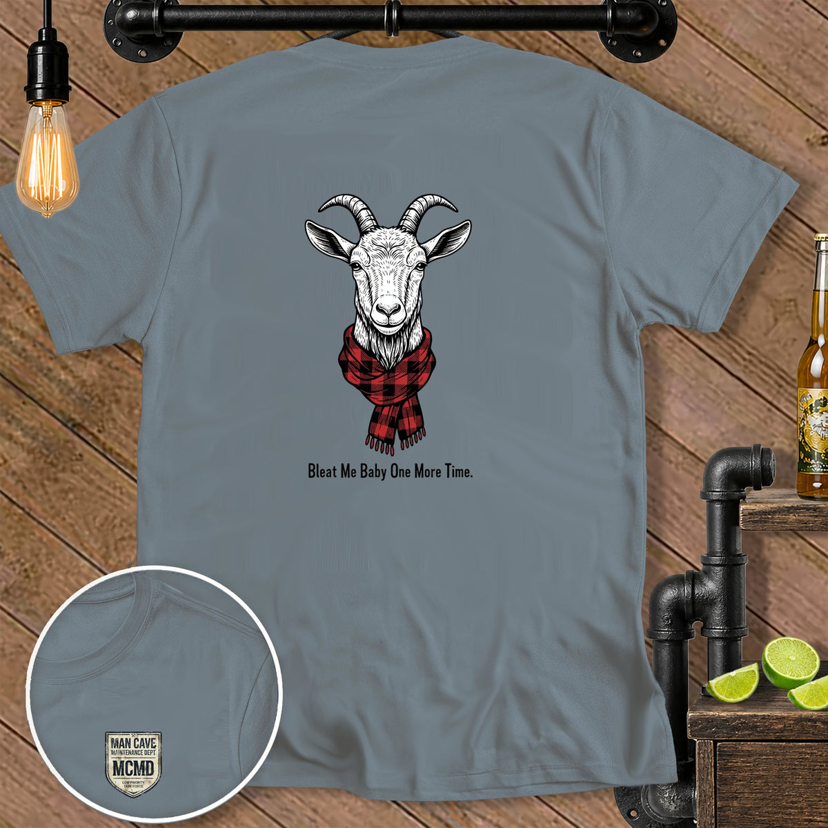 Grey t-shirt with a goat wearing a plaid scarf and text "Bleat Me Baby One More Time."