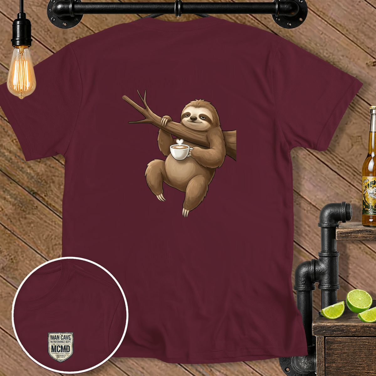 Maroon t-shirt with a sloth holding a coffee cup on a branch and a "MAN CAVE MCMD" logo.
