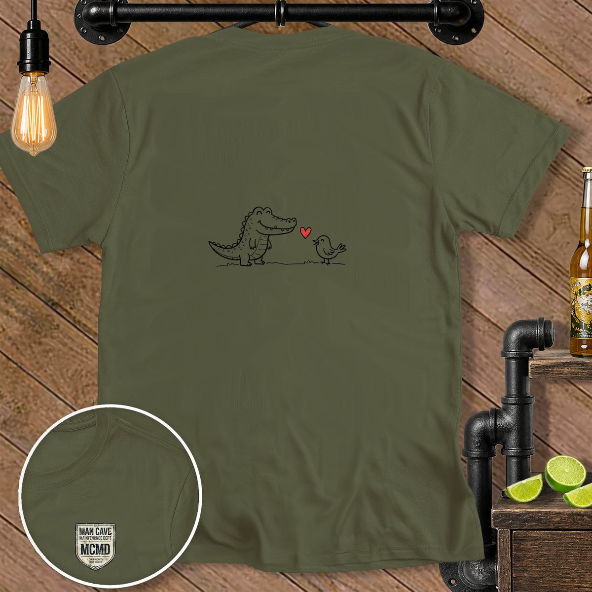 Khaki t-shirt with a black line drawing of an alligator and bird with a heart.