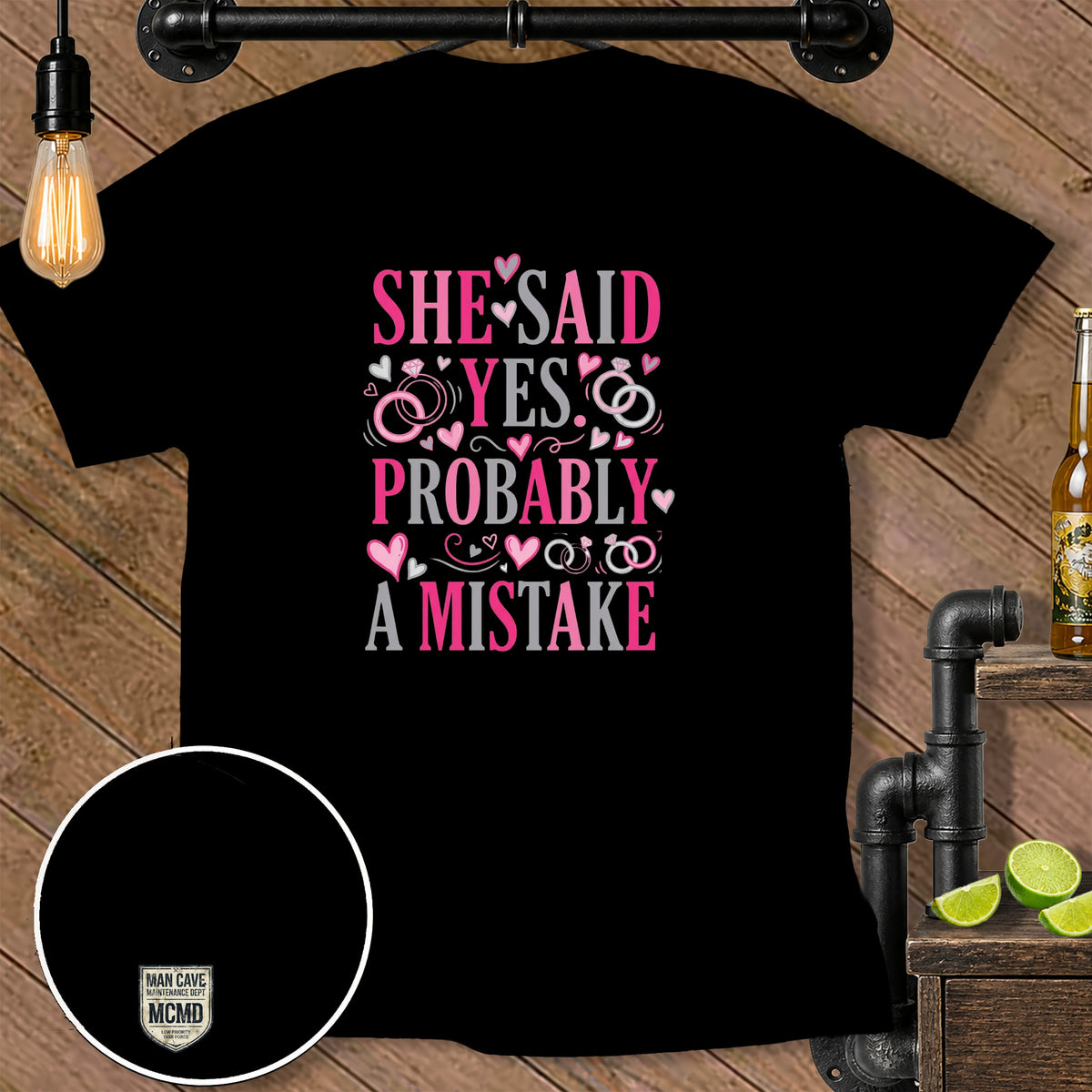 Black t-shirt with "She Said Yes Probably A Mistake" graphic and wedding rings.