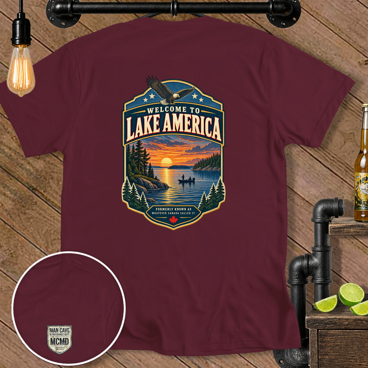 Maroon t-shirt with "Welcome to Lake America" graphic and small "Man Cave Maintenance Dept MCMD" logo.