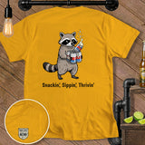 Yellow t-shirt with raccoon holding cans, reads 