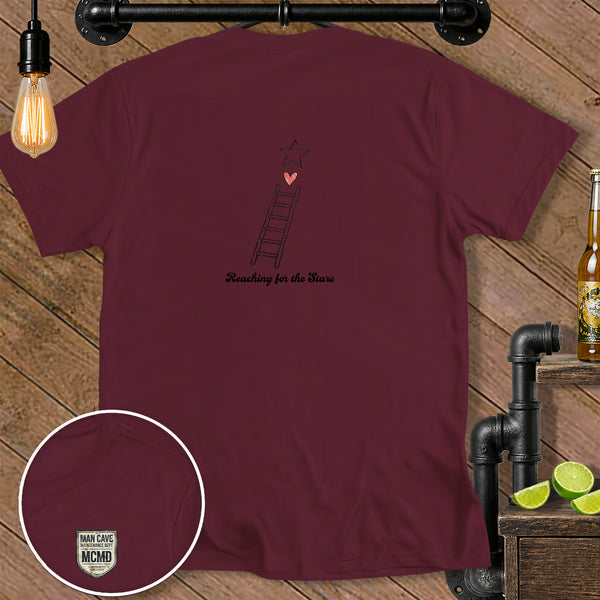 Burgundy t-shirt with ladder, heart, and star graphic and text "Reaching for the Stars".