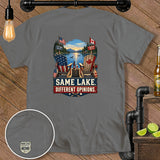 Grey t-shirt with a graphic of two Adirondack chairs, American and Canadian flags, and the text 
