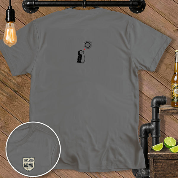 Grey t-shirt with a graphic of a penguin looking up at a swirling sun and a heart.